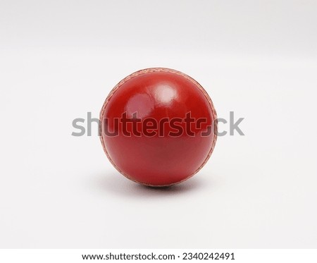 A Shiny New Test Match Cricket Ball Leather Hard Circle Stitch Closeup Picture On White Background