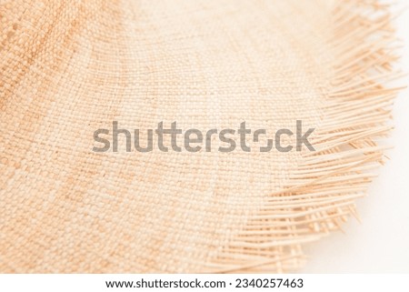 Light straw wicker hat as abstract summer fashion accessory background on white color Royalty-Free Stock Photo #2340257463