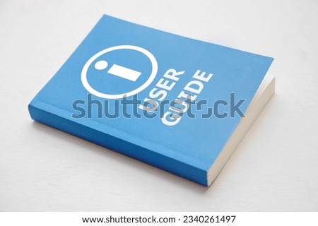 User guide book, Blue cover book on white background, instruction manual for user training  Royalty-Free Stock Photo #2340261497