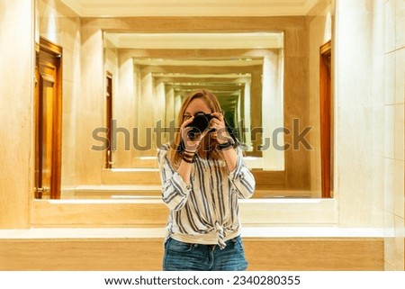 a girl in a mirror with a camera