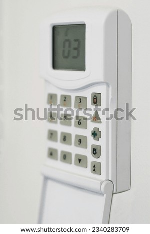 security system console, mounted on a wall, shallow DOF