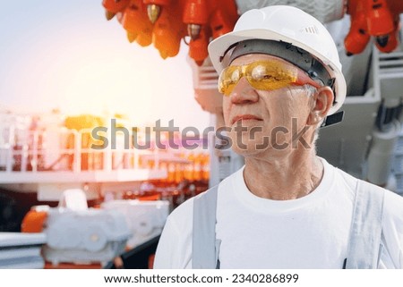 Portrait of miner man standing background industry harvester shearer drill head for coal mine.