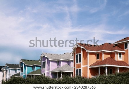 Bright new pastel color beach houses in Nags Head, on the North Carolina Outer Banks Royalty-Free Stock Photo #2340287565