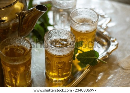 Traditional Moroccan mint tea, cup of Moroccan tea, Traditional Moroccan teapot. Royalty-Free Stock Photo #2340306997