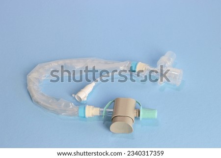 Closed tube suction isolated in a light blue background  Royalty-Free Stock Photo #2340317359