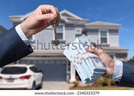 Man Handing a man Thousands of Dollars For Keys in Front of House