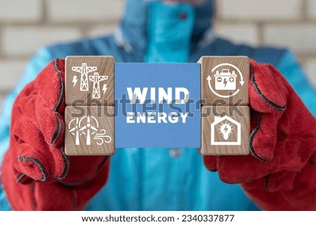 Engineer using virtual touch screen presses inscription: WIND ENERGY. Green wind energy concept. Alternative energy industry. Electricity generation.