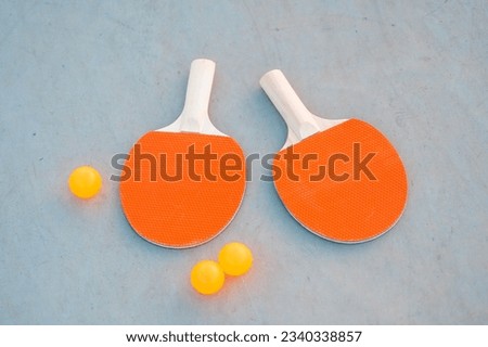 Ping pong paddle and balls on grey background. Table tennis inventory. Close up . Mock-up, copy space, banner. 