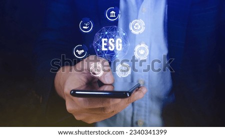 ESG icon concept use a smartphone to analyze ESG for environmental, social and governance in sustainable and ethical business on the Network connection, businessman pressing button on screen.