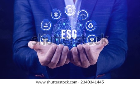 ESG icon concept in the hand for environmental, social and governance in sustainable and ethical business on the Network connection, businessman pressing button on screen.