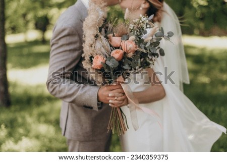 Autumn wedding bouquet of the bride, consists of: chrysanthemums, orange marjoram flowers, white roses, green eucalyptus leaves. Wedding. Autumn Royalty-Free Stock Photo #2340359375