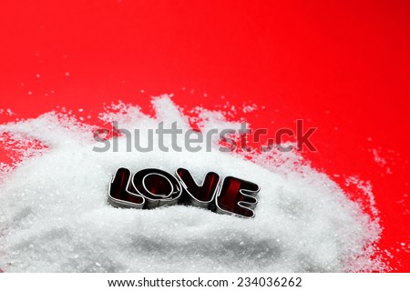 Love text message from cookie form letters on sugar and red background. Valentines Day theme, greeting card.