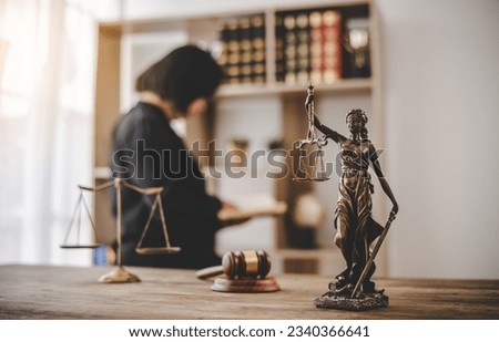Lady Justice Holding Scales of Law in a Courtroom - Symbolizing Equality, Fairness, and Legal Proceedings Royalty-Free Stock Photo #2340366641