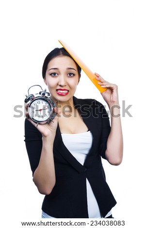 portrait of a  young asian woman in an business outfit holding an alarm clock
