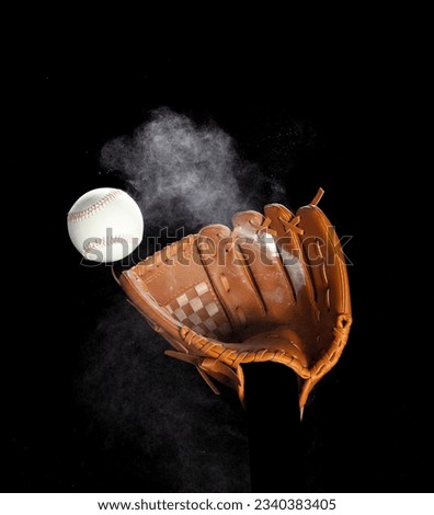 Leather glove mitt receive hit baseball ball and dust soil explode in air. Baseball ball throw and hit to center of mitt glove. Black background isolated freeze action
