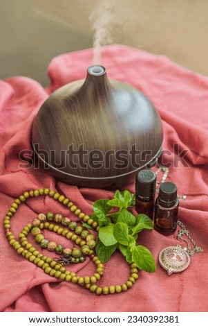 A captivating photo capturing the essence of relaxation and ambiance with an aroma oil and aroma diffuser, creating a soothing and serene atmosphere