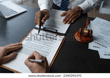 Attorneys or lawyer reading statute of limitations, consulting between male lawyers and business clients, tax firms and examining contract documents in business before signing