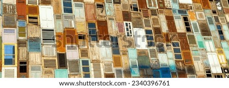 Wall with old colorful arrangement of doors and windows
