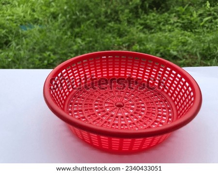 A small basket for storing utensils in the kitchen.