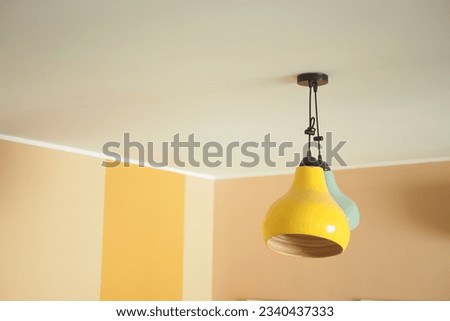  colorful ceiling lamp hanging in a room , Royalty-Free Stock Photo #2340437333