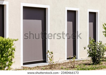 Window Blinds. Modern Fabric Roller Blind on Large Panoramic Windows Door. External Shutters on Window or Terrace Door. Royalty-Free Stock Photo #2340466173