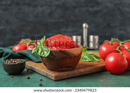 Bowl of canned tomatoes and peppercorns on color table
