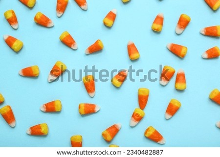 Tasty Halloween candy corns on blue background