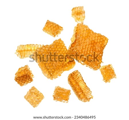 Flying sweet honeycombs on white background Royalty-Free Stock Photo #2340486495