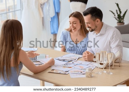 Young couple planning their wedding in office