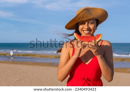 Portrait of a woman eating a watermelon by the beach. Close-up smiling with bikini