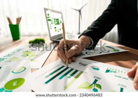 ESG environmental social governance display on laptop on eco-friendly company with businessman planning on environmental protection initiative for clean and sustainable future ecology. Trailblazing Royalty-Free Stock Photo #2340496483