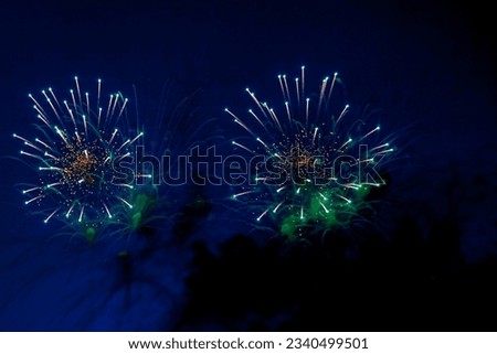 Amazing holiday colorful firework display on celebration, showing. Fireworks with sparks, colored stars and bright nebula on black night sky universe, comets. Festive concept. Copy text space
