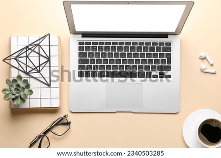 Composition with modern laptop, earphones and stationery on color background