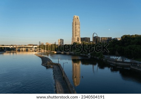 Minneapolis skyline with reflection in the mississippi river. Shot on the stone arch bridge in Minneapolis, Minnesota, USA.