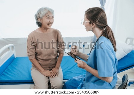 Young beautiful smiling doctor nurse caring to help happy senior grandmother helping old patients in rehabilitation at elderly health checkup