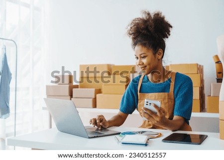 Pretty African American sme business woman working Custom Ecommerce Packaging leading supplier of custom packaging. create a personalised experience, fast production and competitive pricing Royalty-Free Stock Photo #2340512557