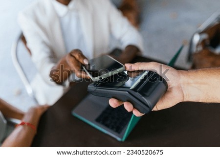 Seamless Payment: Close-Up of African American Businesswoman Making Mobile Payment Royalty-Free Stock Photo #2340520675