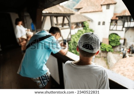 Tourists making photo in legendary Bran (Dracula) historical castle of Transylvania, Brasov region, Romania.