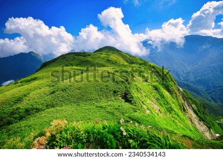 A dark green ridgeline that continues from the summit of Amakazari, one of Japan's 100 famous mountains in Japan Royalty-Free Stock Photo #2340534143