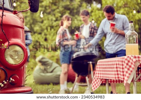 Blurred image of people, friends meeting together, making barbecue party, drinking cocktails and enjoying warm day outdoors. Concept of friendship, leisure time, weekends, summer, party
