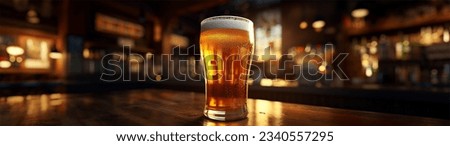 Cold beer in a glass, close up in a dark  pub with a sunset light on it. Beer banner.