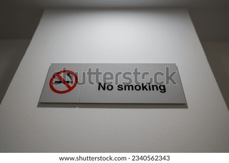 No smoking sign hangs on the wall.