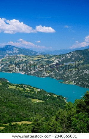 Aerial view on blue lake of Serre-Poncon, reservoir border between Hautes-Alpes and Alpes-de-Haute Provence   departments, one of largest in Western Europe