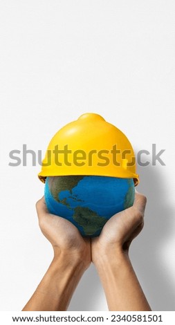 Globe with safety helmet. Labor day concept