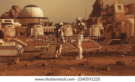 Two astronauts in spacesuits walk toward research station, colony or scientific base on Mars. Solar cell and panels. Space mission on red planet. Futuristic colonization and space exploration concept. Royalty-Free Stock Photo #2340591225
