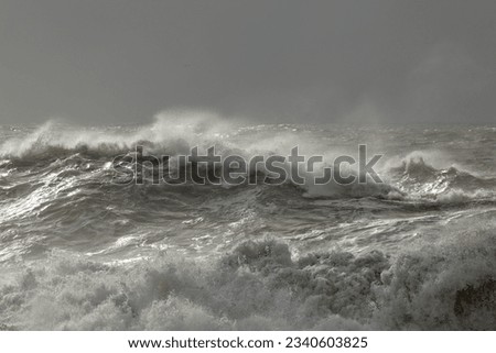 Stormy sea waves with interesting winter light before rain