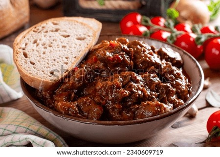 Beef goulash, soup and a stew, made of beef chuck steak plenty of paprika. Hungarian traditional meal. Beef stew - goulash Royalty-Free Stock Photo #2340609719