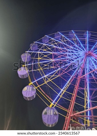 beautiful picture of Ferris wheel in the night mode, the beautiful colors emitted by the lights from the ferris wheel
