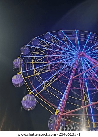 beautiful picture of Ferris wheel in the night mode, the beautiful colors emitted by the lights from the ferris wheel