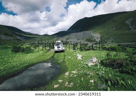 Driving off road car in high altitude mountains in Sichuan province, China Royalty-Free Stock Photo #2340619311